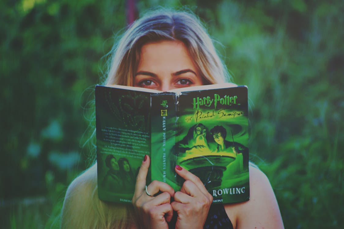 Free Woman Reading Harry Potter Book Stock Photo
