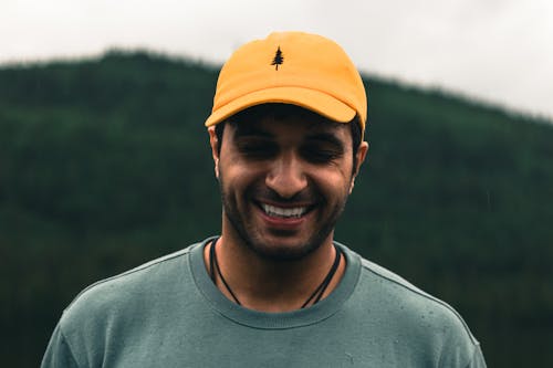 A Man in Gray Shirt Wearing Yellow Cap