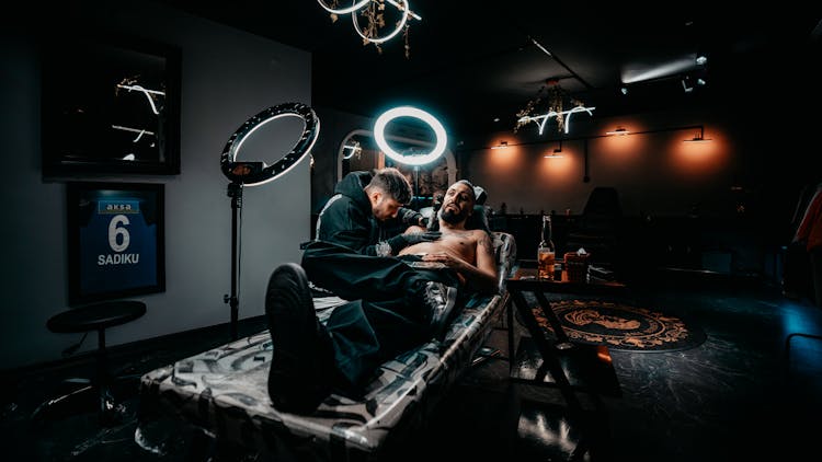 Tattooer Working On Customer At Studio