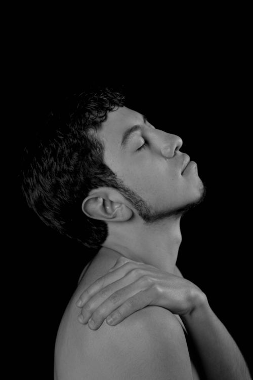 Free Thoughtful black and white portrait of a relaxed man on a dark background. Stock Photo