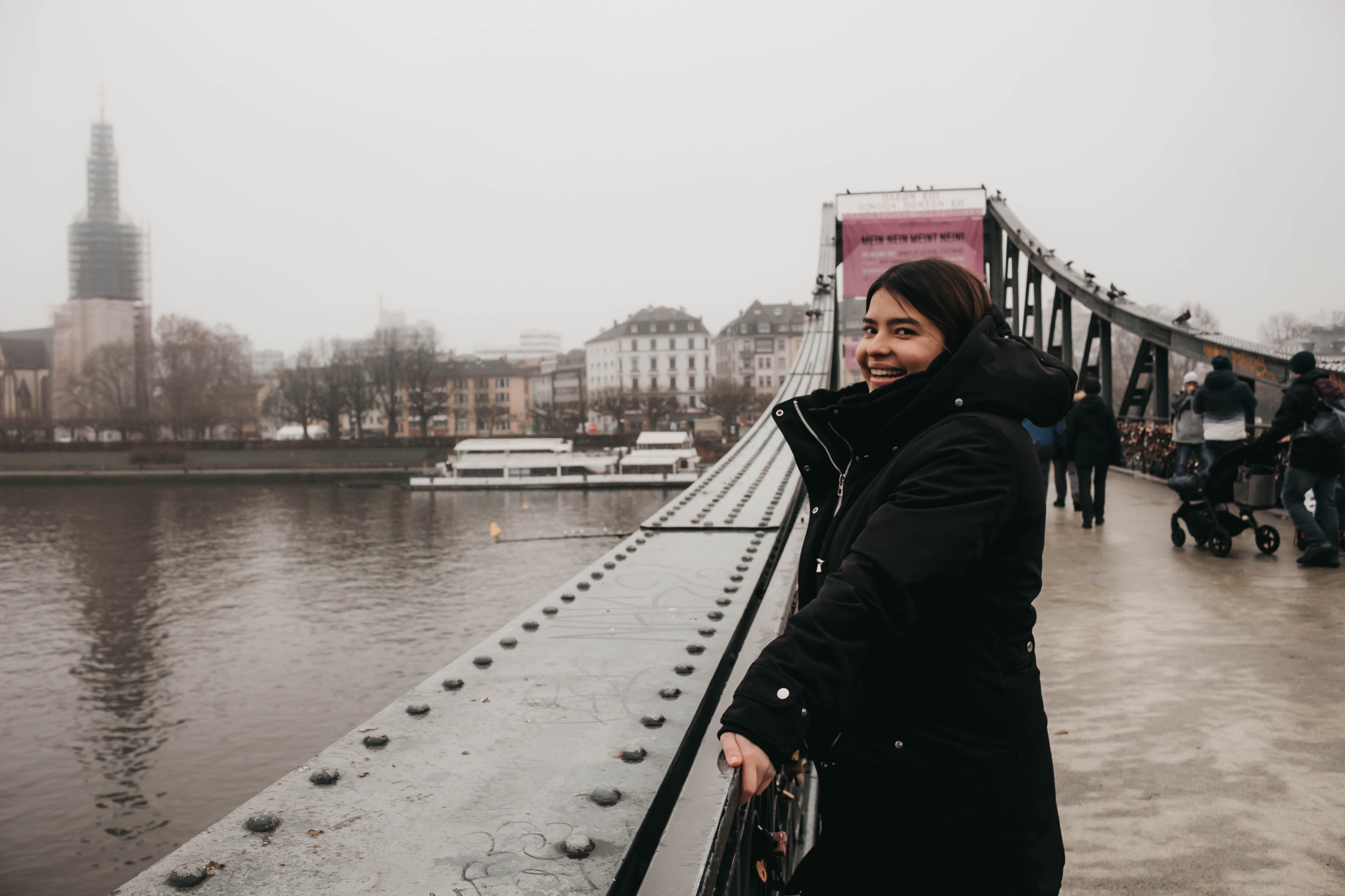 Woman in Black Jacket Standing on the Bridge · Free Stock Photo
