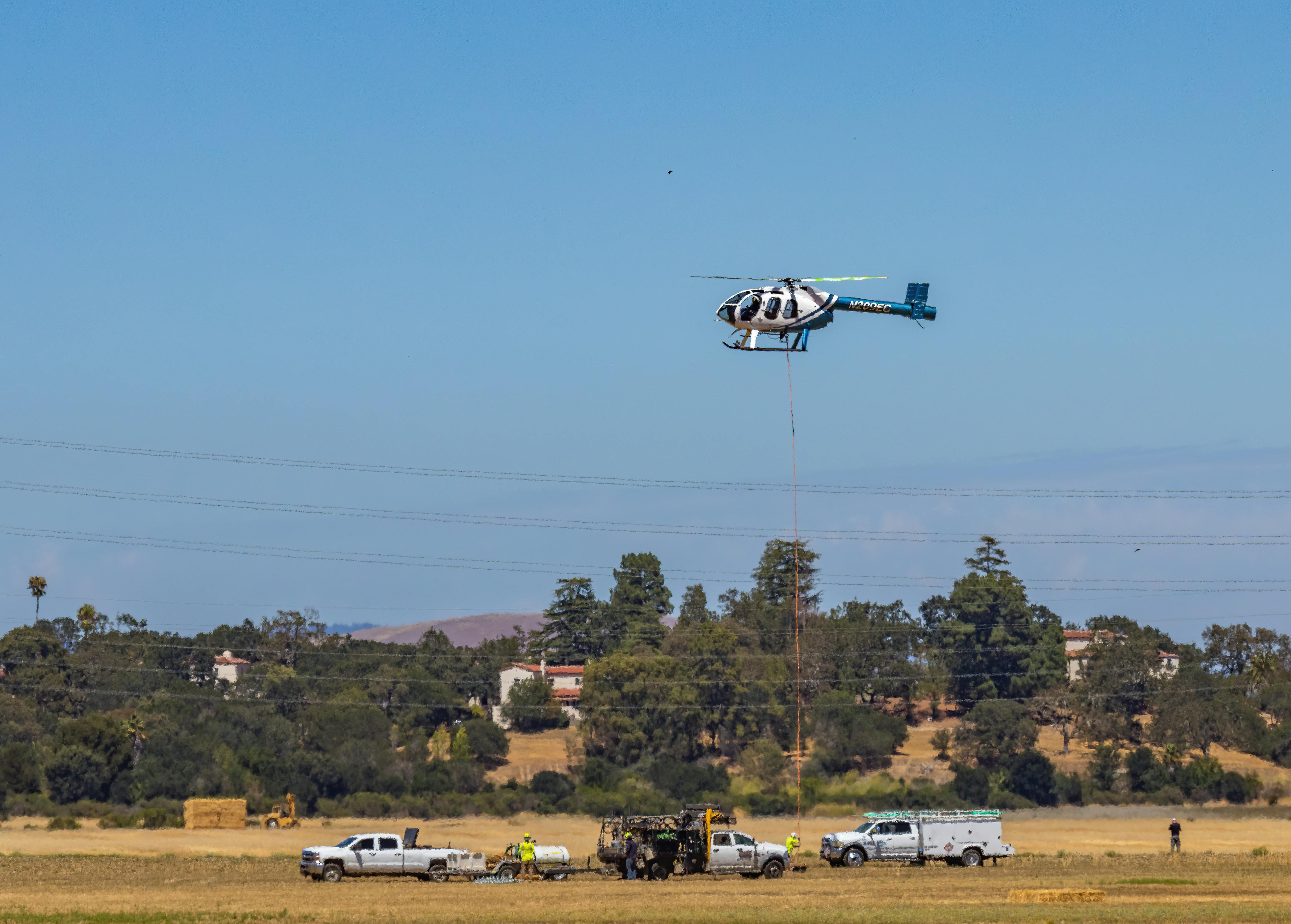 helicopter being used as aerial crane for transmission line work - Crane use in the construction of electrical transmission lines