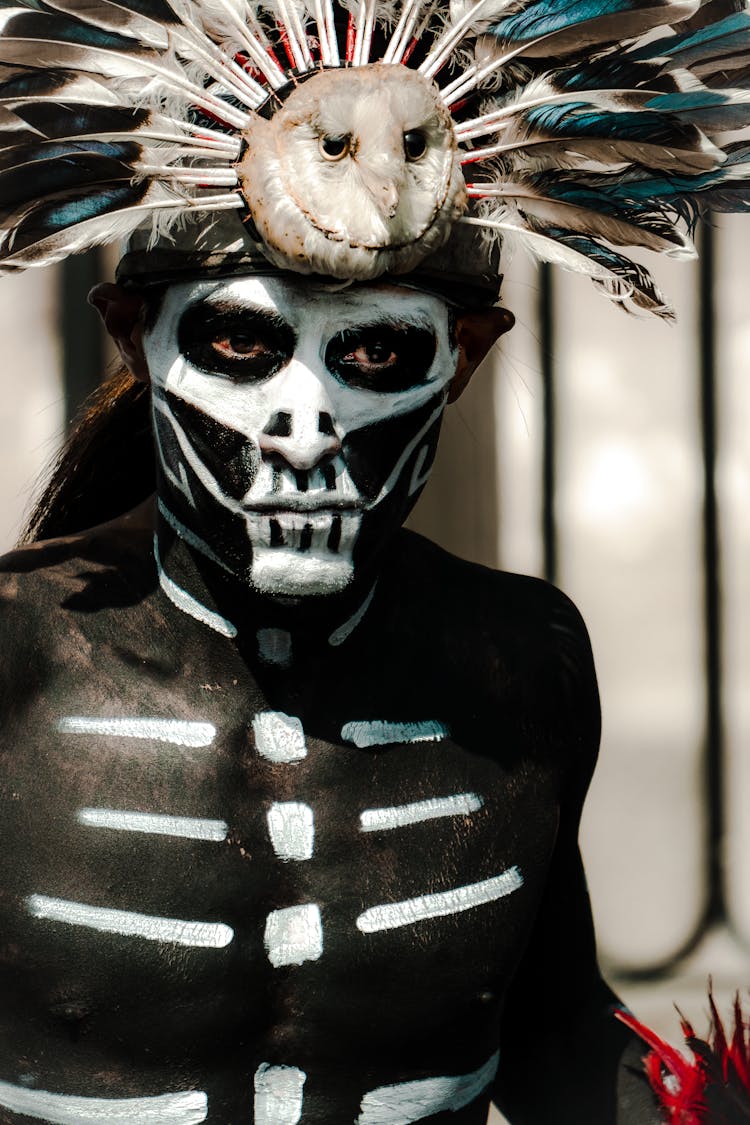 Man With Traditional Mexican Dead Face Paint And Feather Headdress