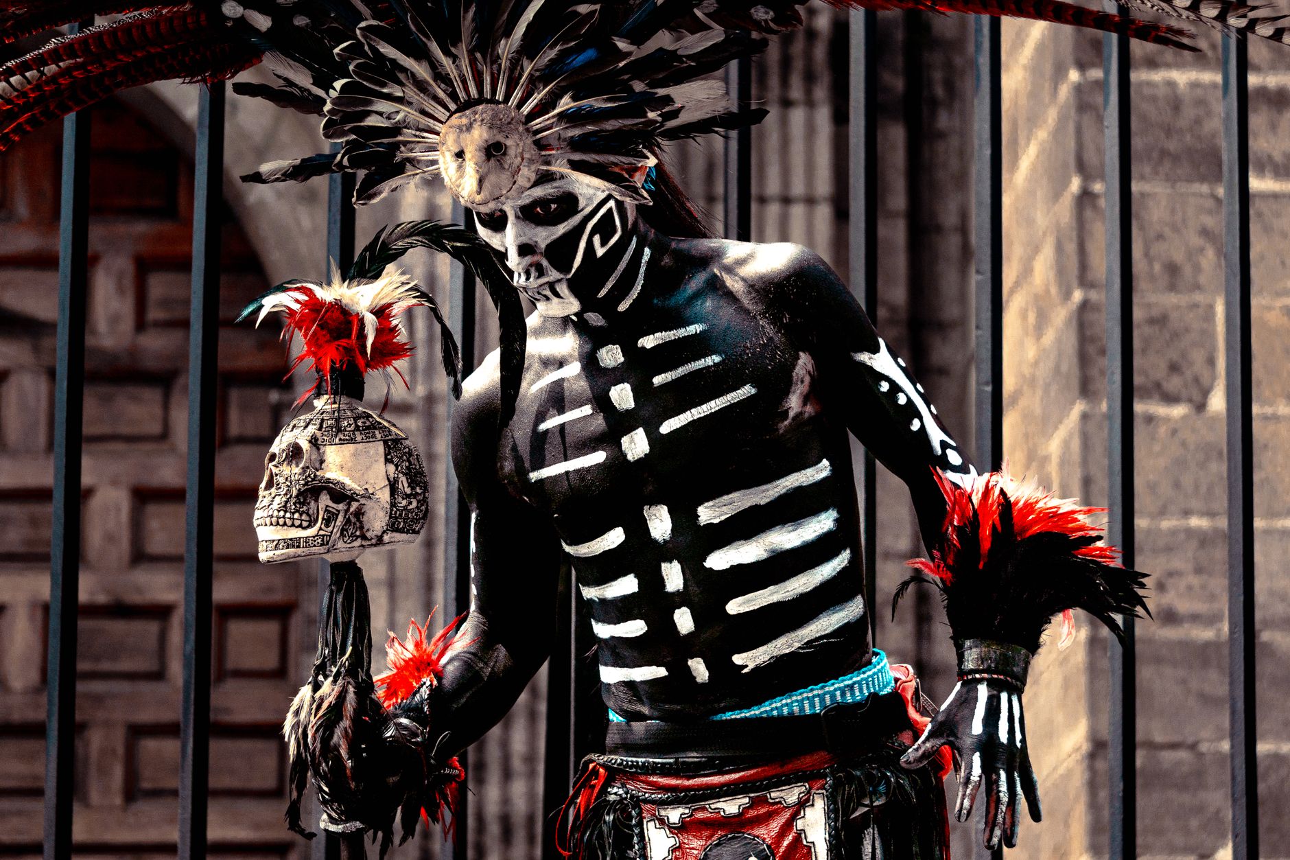 Man in decorated traditional attire for Dia de los Muertos in Mexico City.