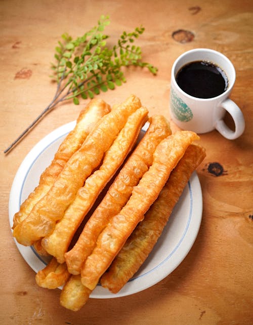 Close-Up Shot of Youtiao and a Cup of Coffee 