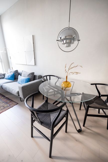 Chic living room setup featuring a glass dining table and stylish furniture in Philadelphia.