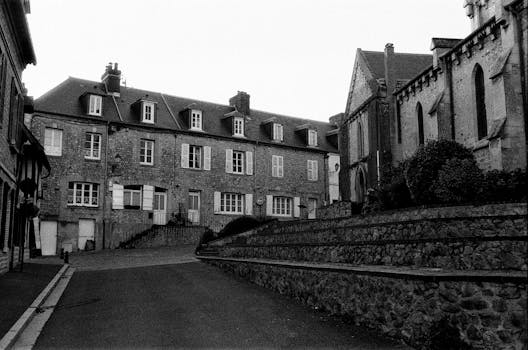 Black and white photo of historic European buildings showcasing stone architecture.