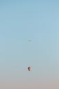 Plane Flying over a Balloon in the Sky