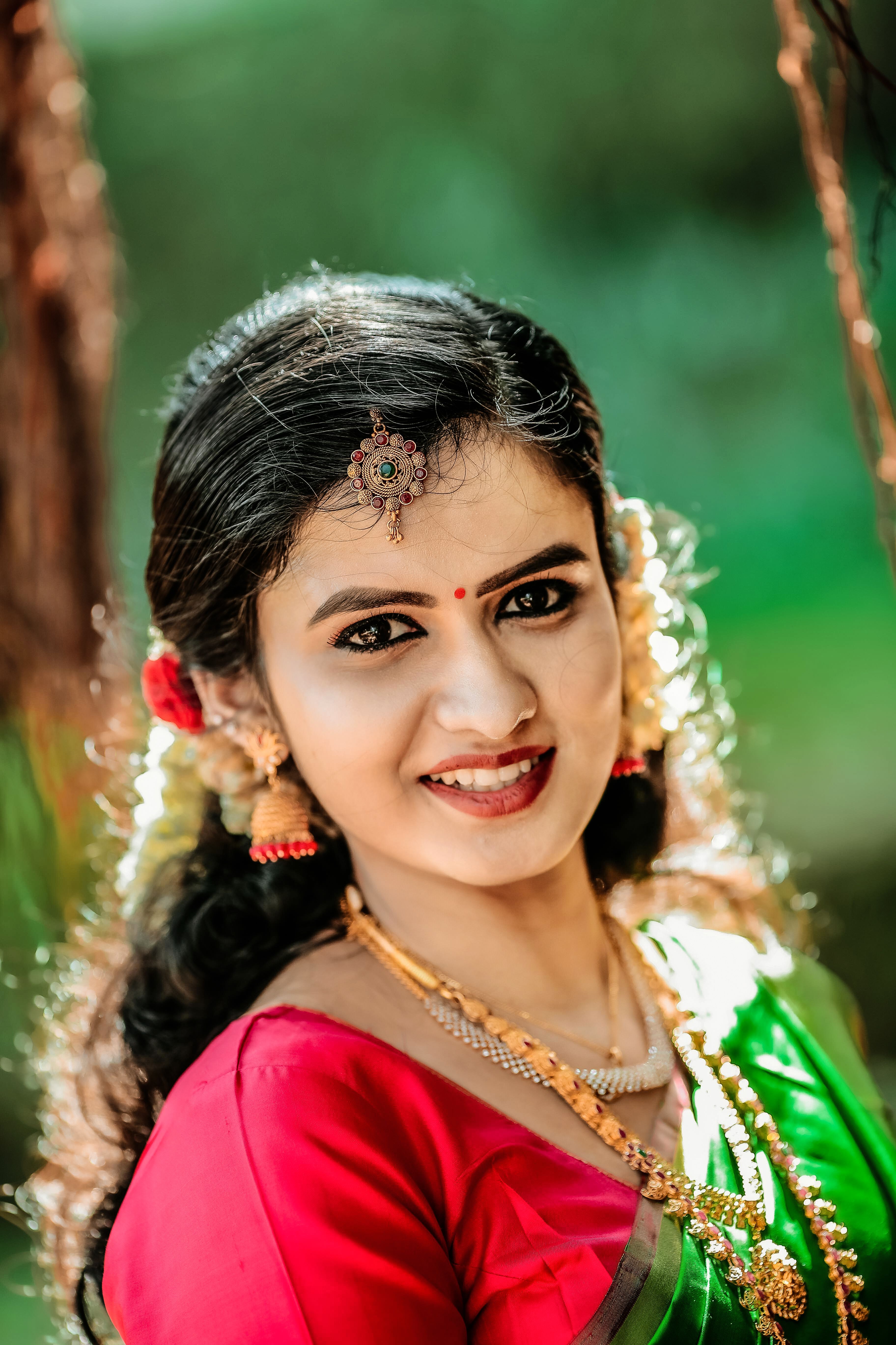 Young Woman in a Traditional Dress Sitting Outdoors · Free Stock Photo