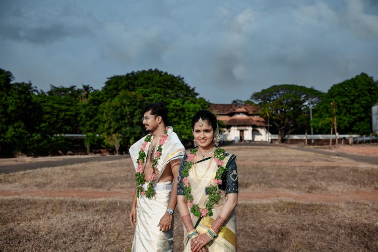 Man And Woman In Traditional Indian Clothing Standing In The Field 