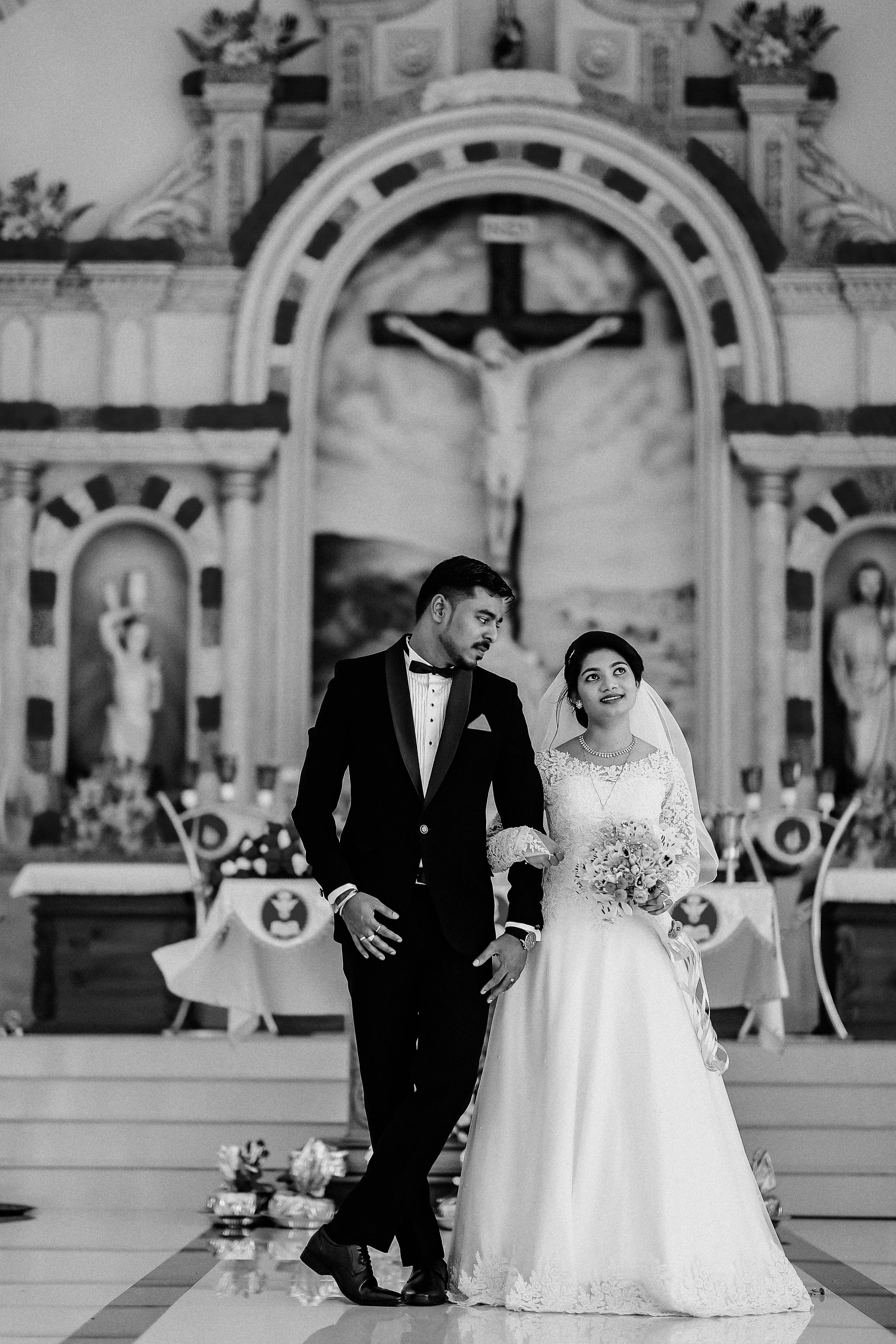 black and white photo of newlywed couple in church