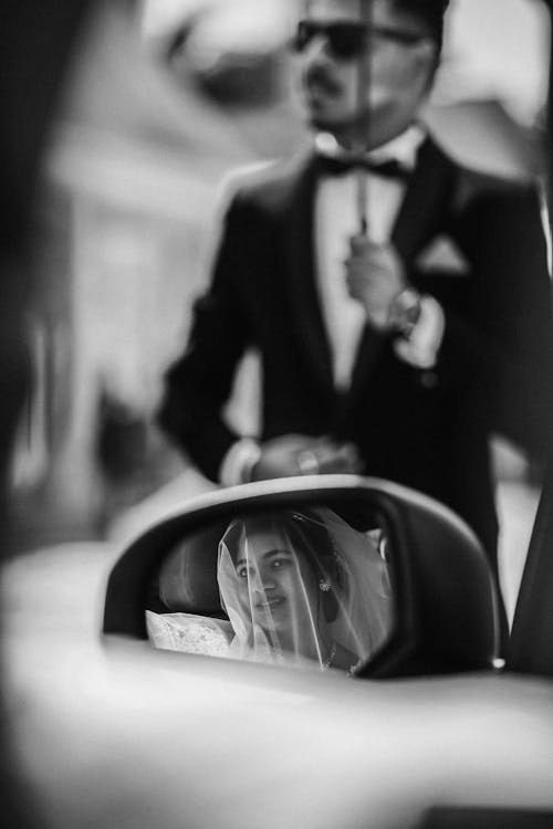 Reflection of a Bride in the Side Mirror of a Car