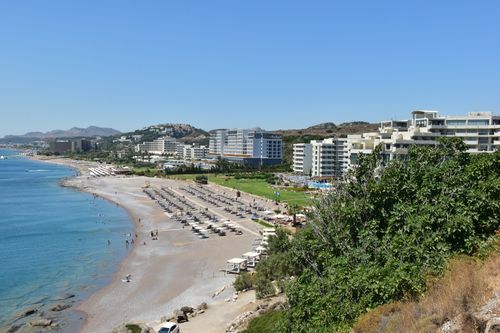 Free Scenic aerial view of a coastal resort with sandy beach and blue ocean. Stock Photo