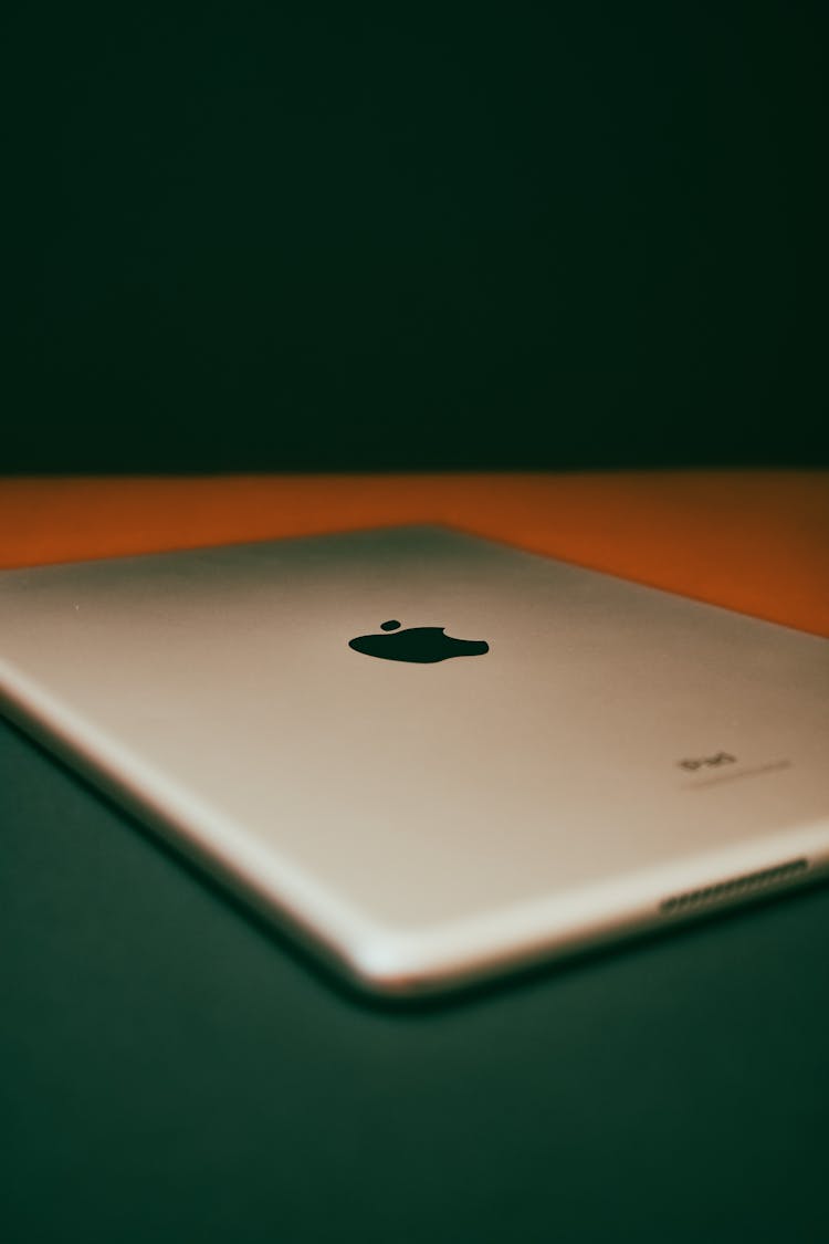 A Silver Ipad On A Flat Surface