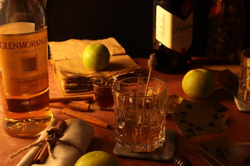 Clear Drinking Glass With Whisky on Wooden Table