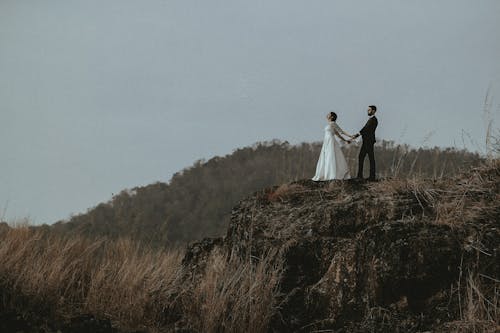 Couple Standing on the Rock Formation