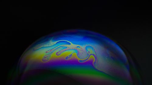 Free Close-up of a vibrant and colorful soap bubble surface with flowing liquid patterns. Stock Photo