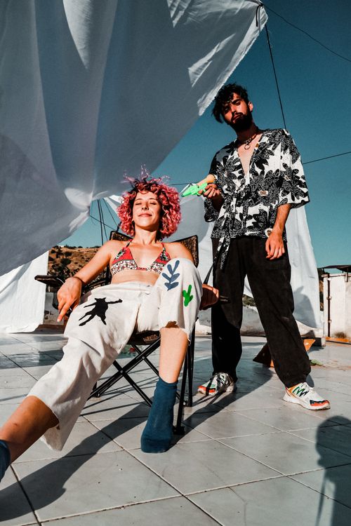 Free A vibrant rooftop photoshoot featuring two stylish individuals in trendy summer outfits. Stock Photo
