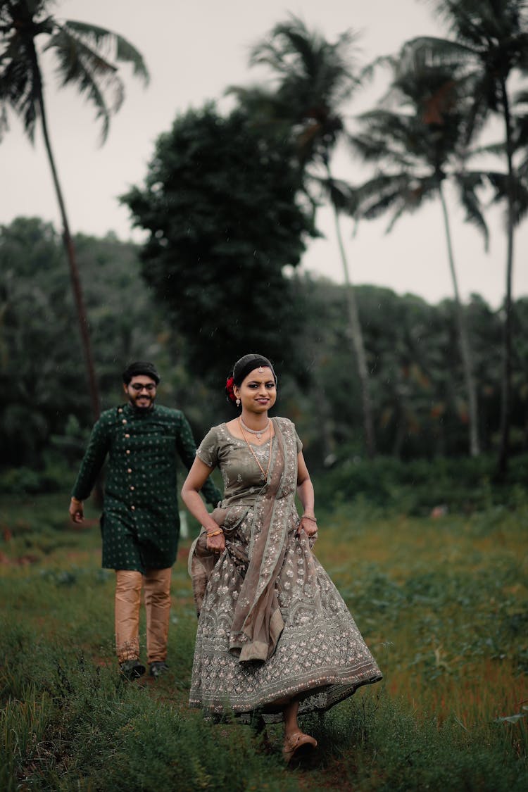 Smiling Woman And Man Walking In Traditional Clothing