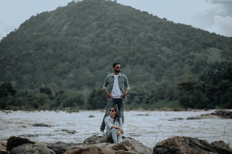 A Couple On Big Rock Near A Lake 