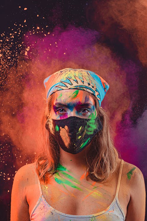 Portrait of Woman in Buff, Mask and with Colorful Powder around