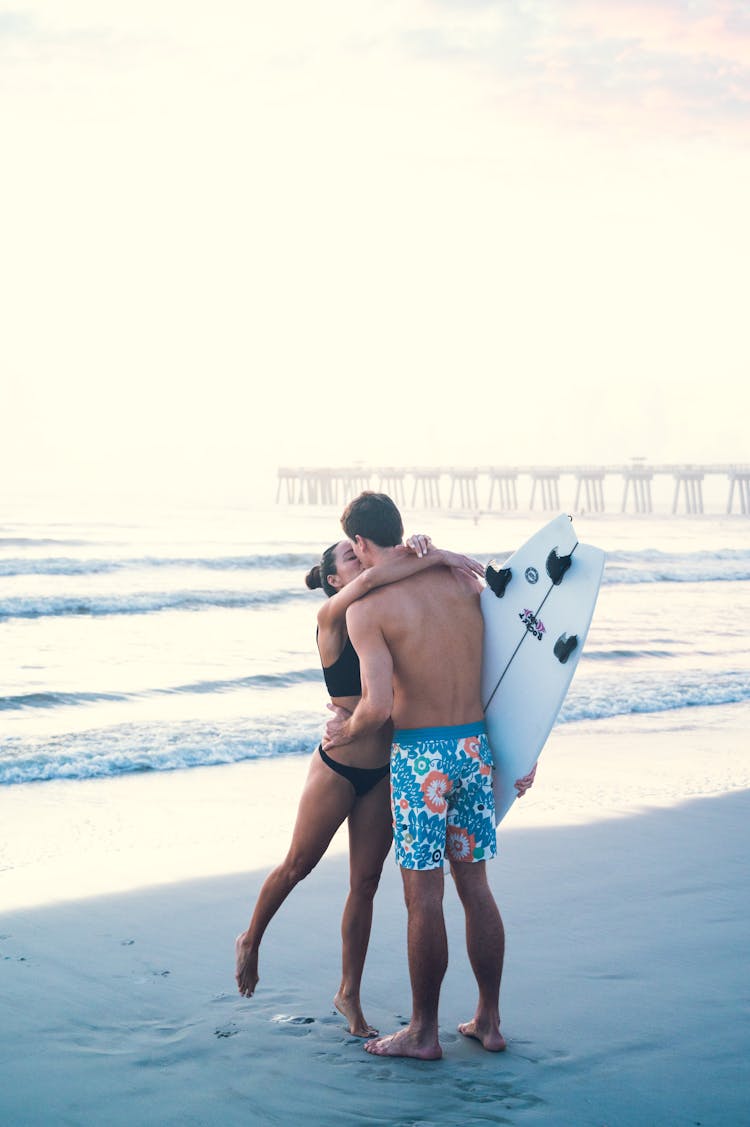 A Couple Kissing At The Beach