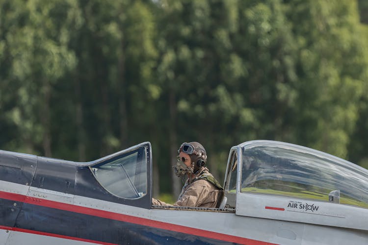 Pilot Sitting On Air Fighter Jet Wearing Gas Mask