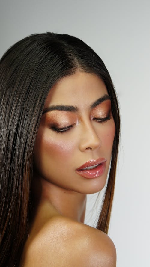 Close Up Photo of Woman with Makeup Wearing Lip Gloss