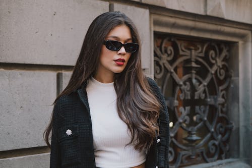 A Woman in a Jacket Wearing Sunglasses