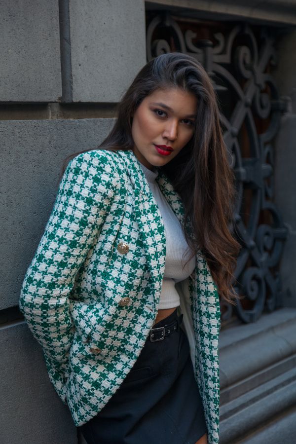 Woman in houndstooth blazer and black dress