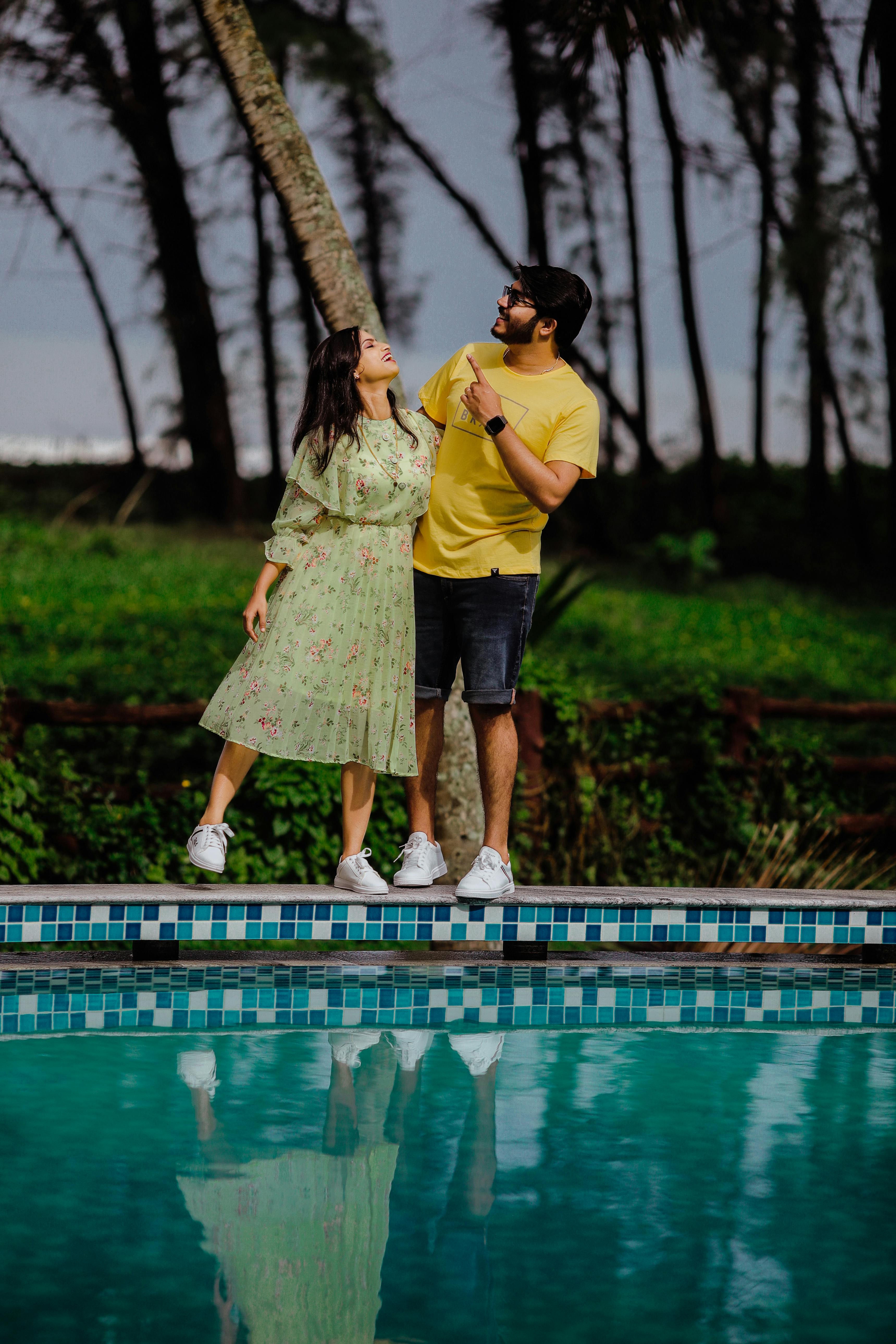 A Couple Sitting by a Pool · Free Stock Photo