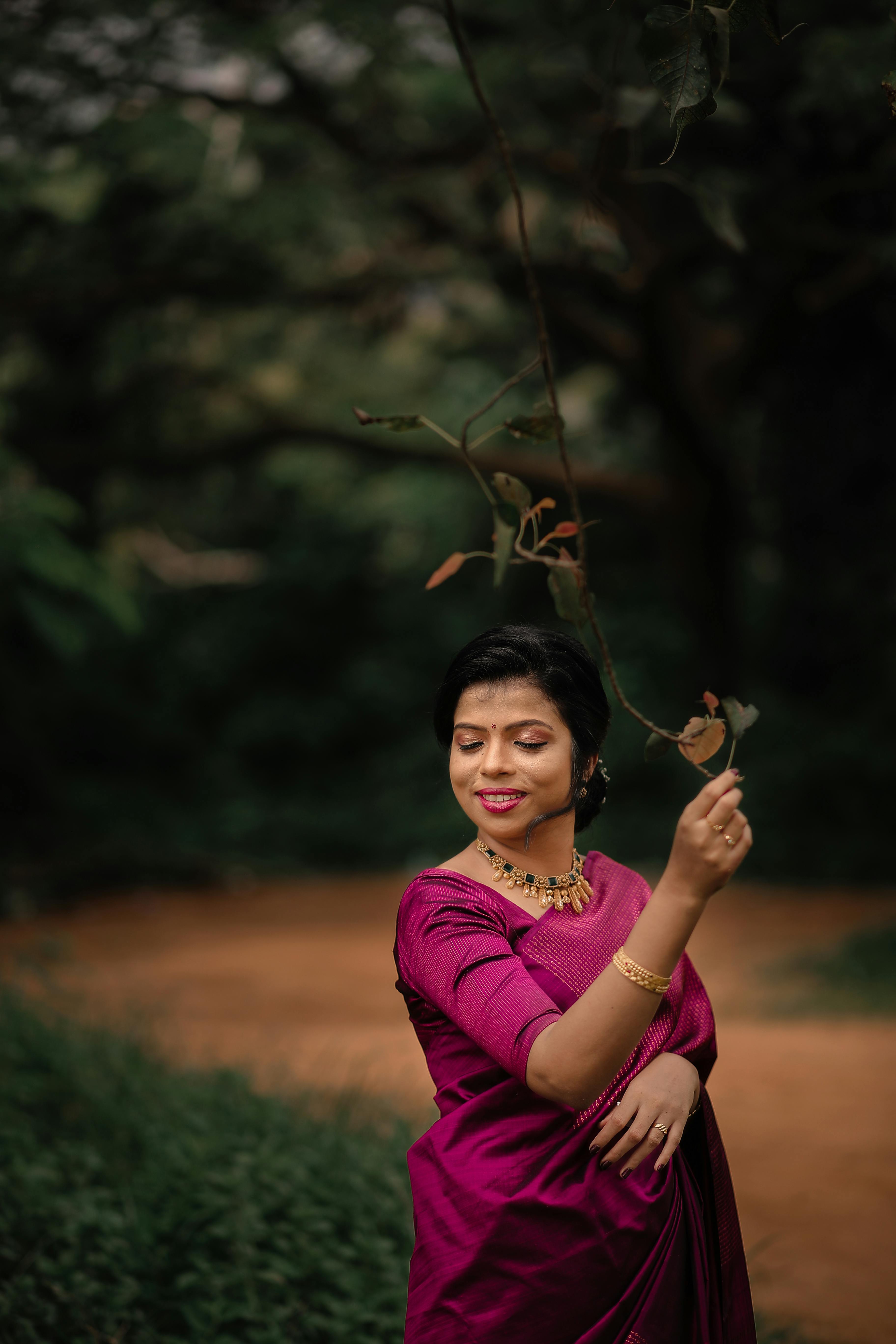 a woman in a traditional sari poses for a photo. AI-Generated 30363104  Stock Photo at Vecteezy