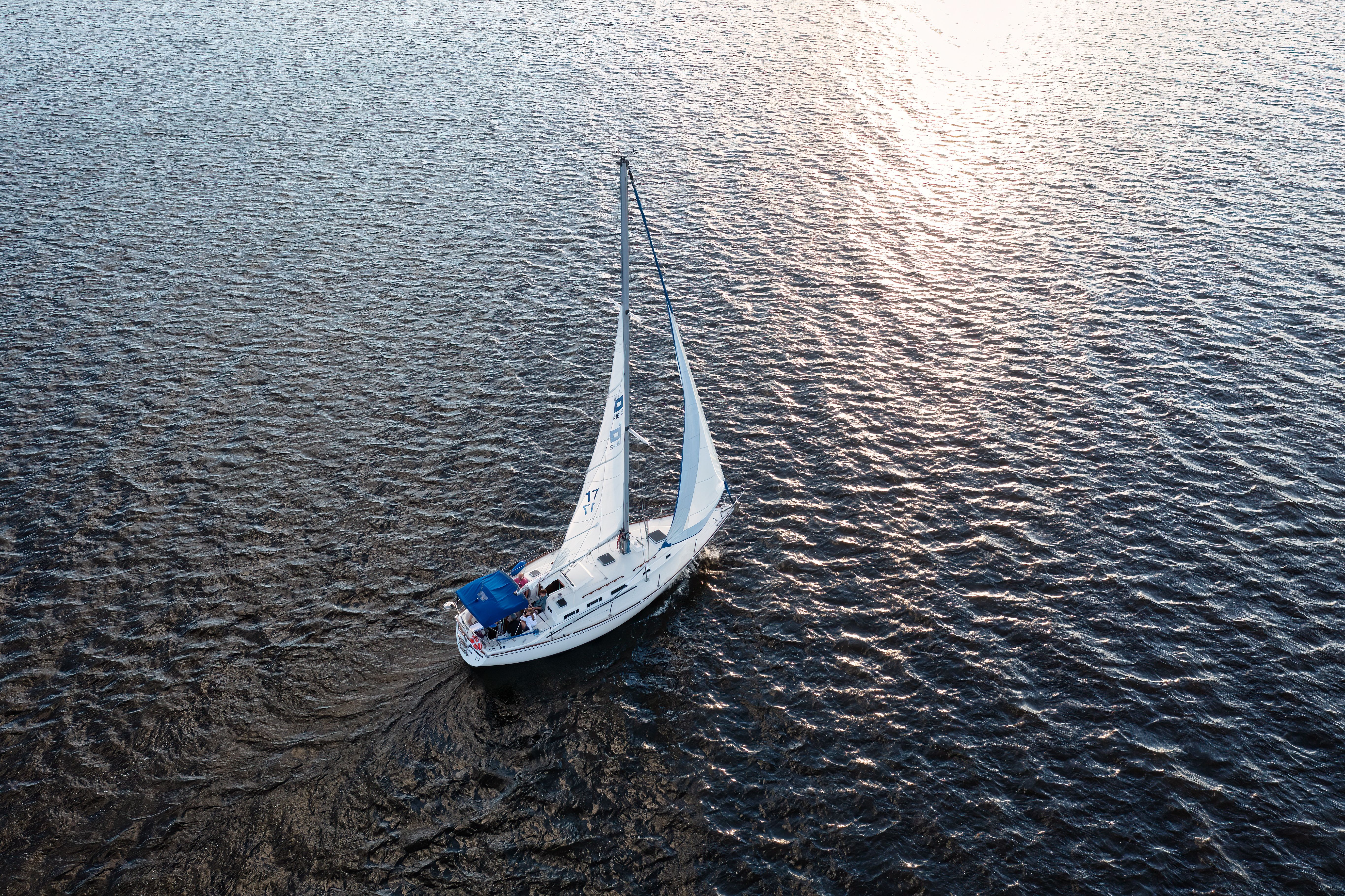 Boat sailing at dawn aerial