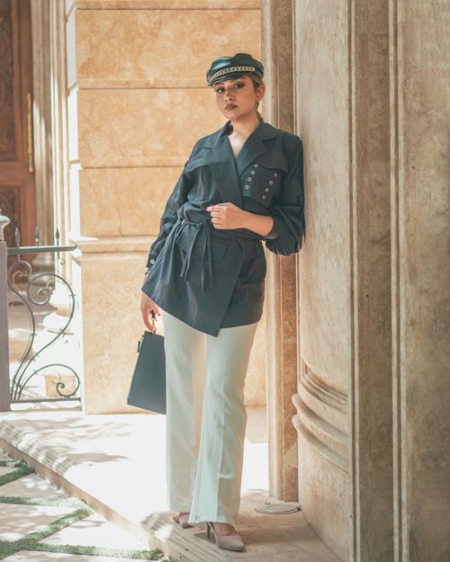 Free A fashionable woman in Isfahan, Iran, stylishly posing against a stone wall. Stock Photo