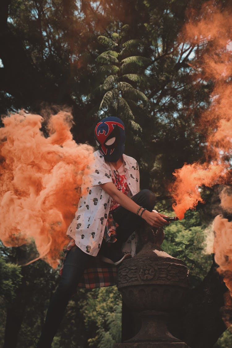 A Person Holding A Smoke Bomb