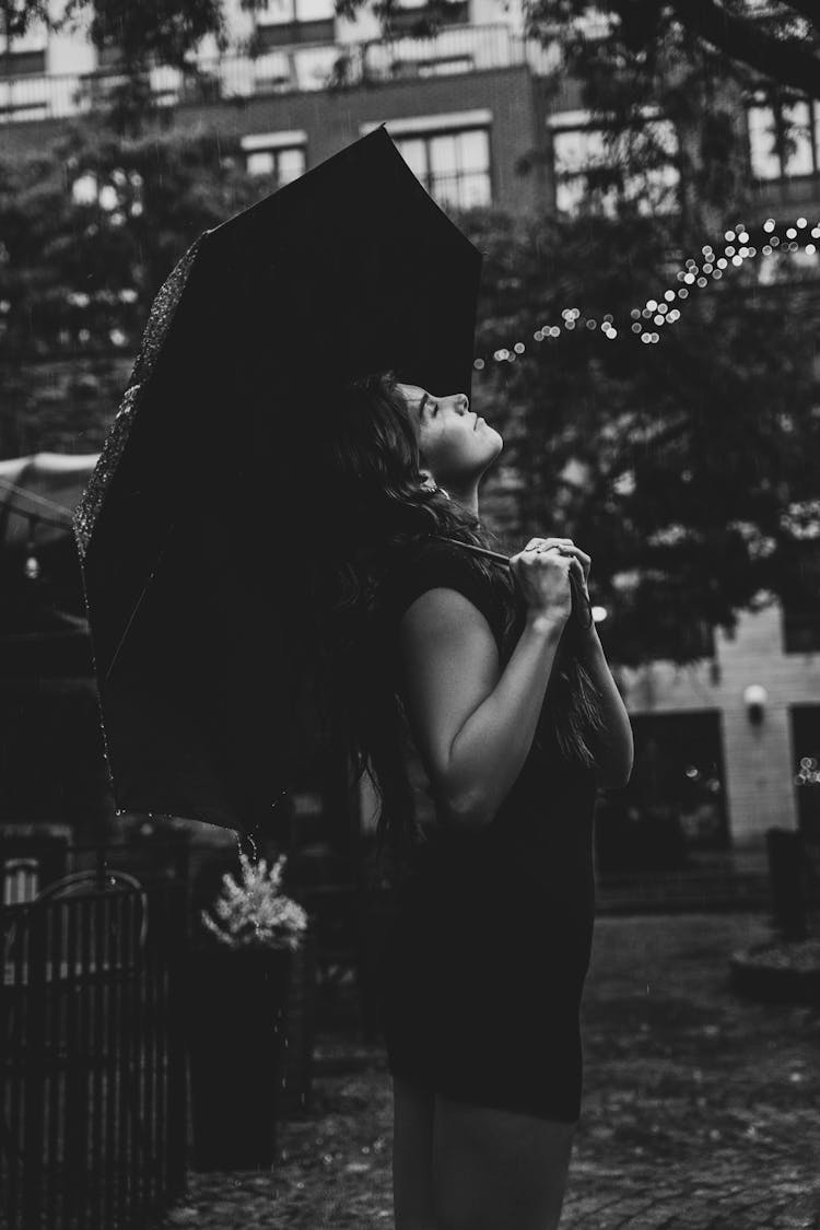 Grayscale Photo Of A Woman Holding An Umbrella