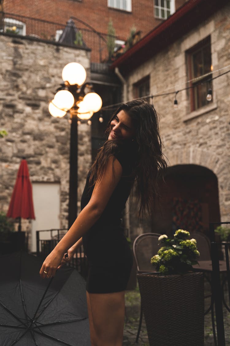 Woman In Black Dress Holding An Umbrella