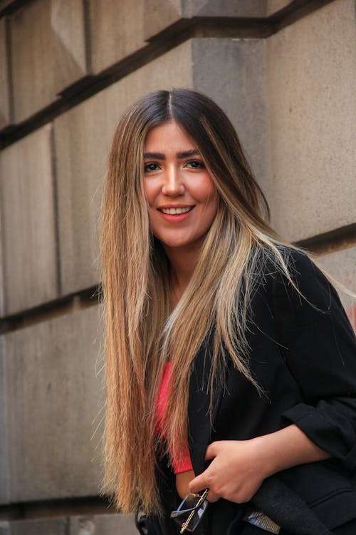 A Woman in Black Blazer Smiling at the Camera