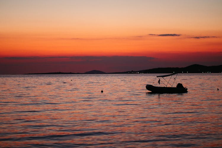 A Boat On A Sea During Sunset