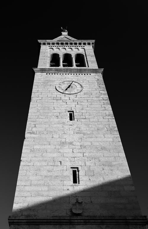 Grayscale Photography of Brown Brick Tower With Clock