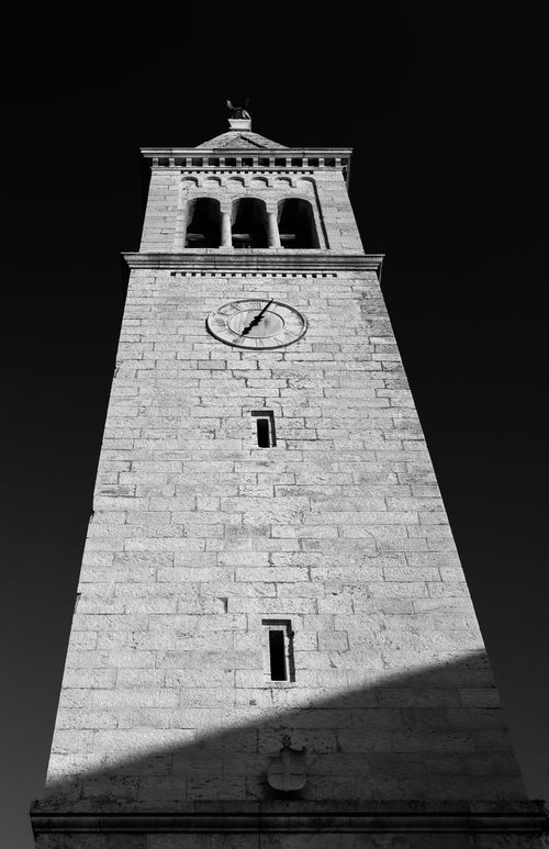 Free Low angle view of a gothic clock tower in monochrome, highlighting stone detail. Stock Photo