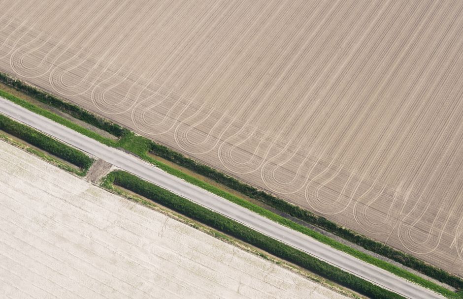 An aerial view of Dutch cropland broken into an intricate patchwork of separately worked field parcels, near Soest, Netherlands.