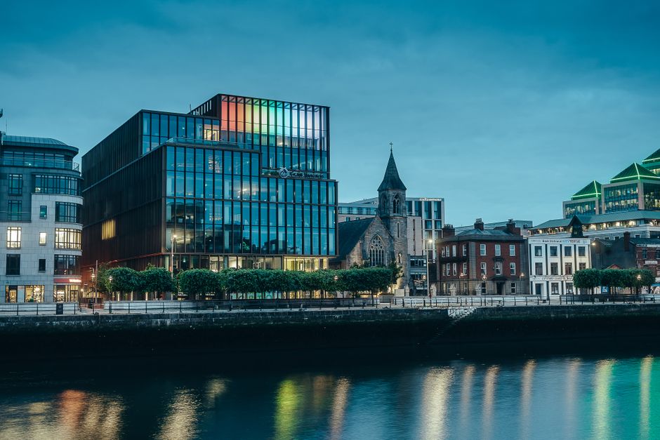Evening view of Dublin's modern waterfront architecture with colorful reflections along the Liffey River.