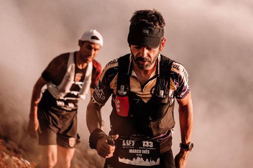 Free Two male athletes competing in a challenging outdoor trail race with determination. Stock Photo