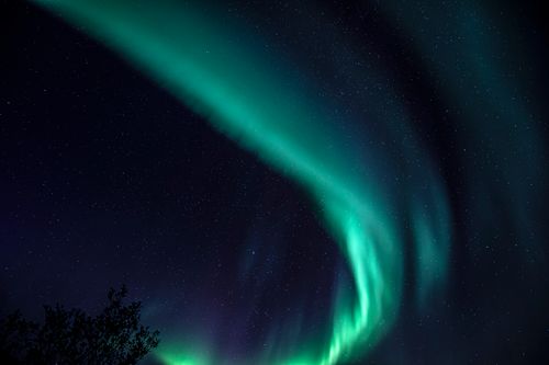 Free Breathtaking view of aurora borealis over Sund, Nordland, Norway's starry night sky. Stock Photo