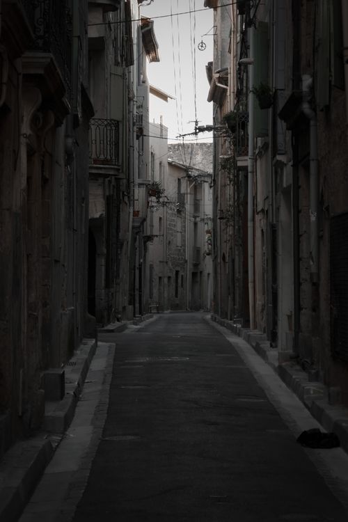 Free Explore the mysterious atmosphere of a narrow city alley with aged buildings. Stock Photo
