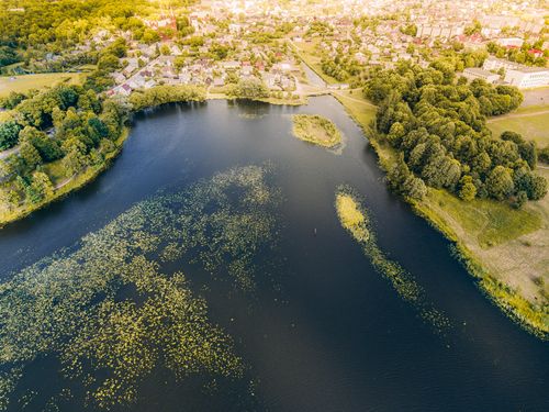 Free Stunning aerial view of Plungė's lake, showcasing nature and urban landscape harmony. Stock Photo