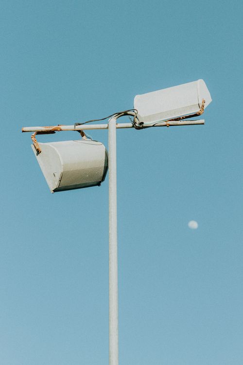 Free A minimalistic street lamp under a blue sky with a distant moon, captured in Aracati, Brazil. Stock Photo