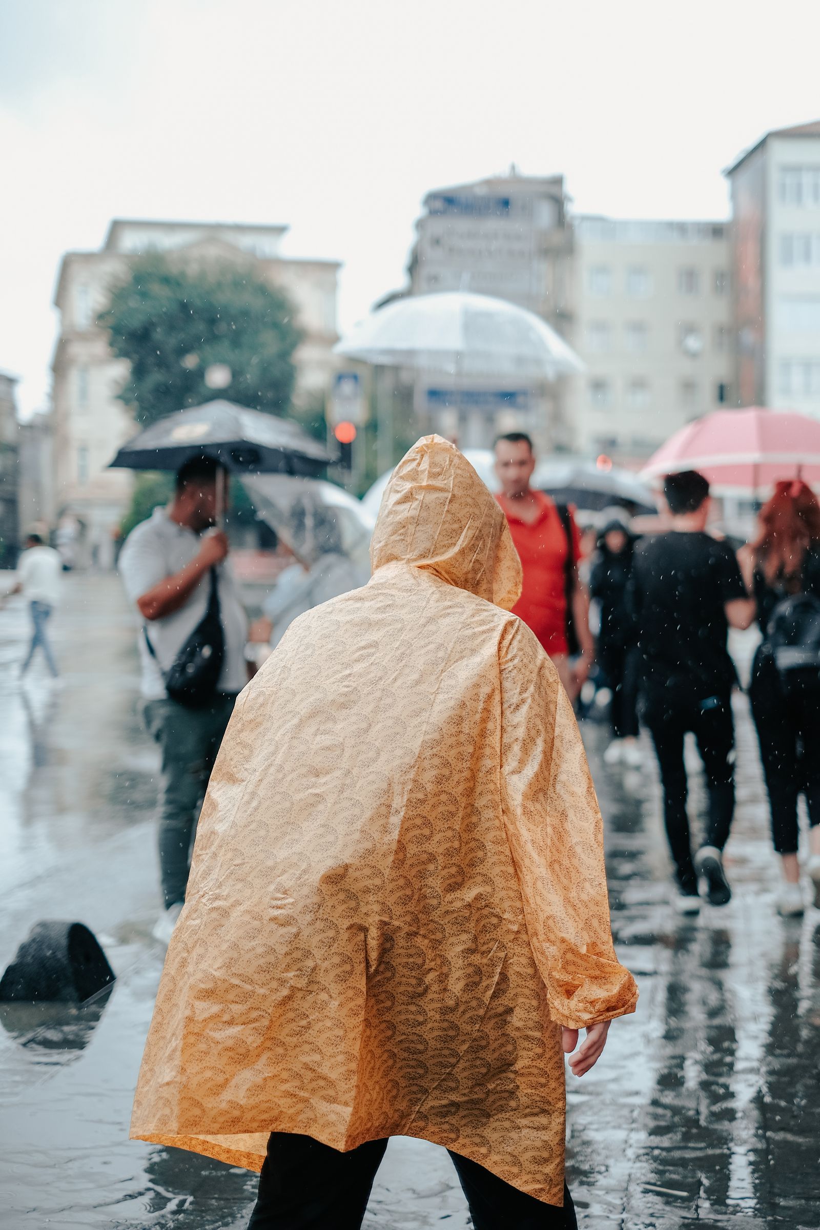 Travellers moving through a colourful city street in changing weather