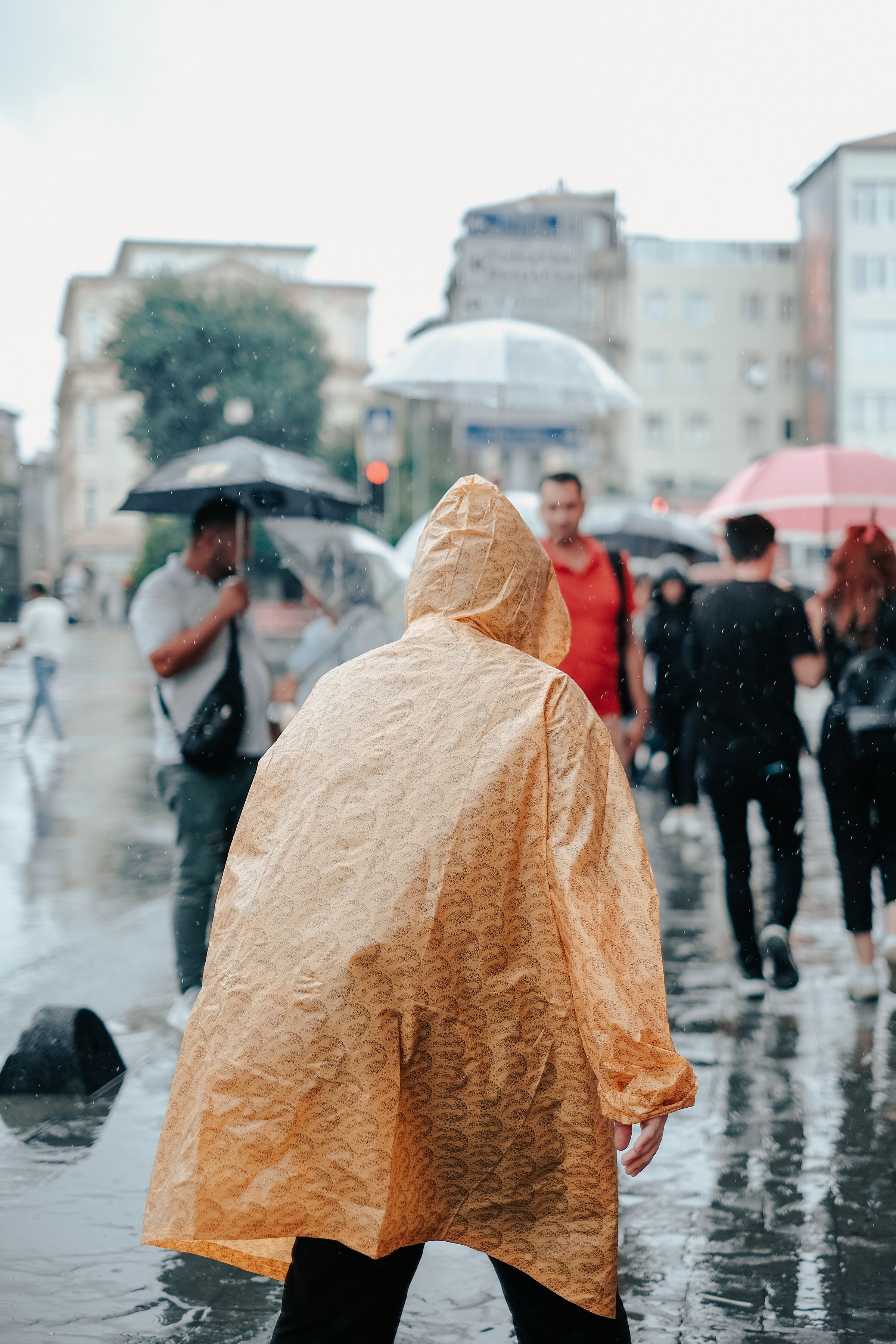 People walking on a rainy city street with colorful umbrellas